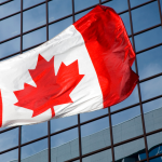 Canadian flag waving in the wind, symbolizing new opportunities for immigrants