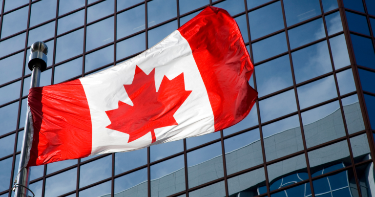 Canadian flag waving in the wind, symbolizing new opportunities for immigrants